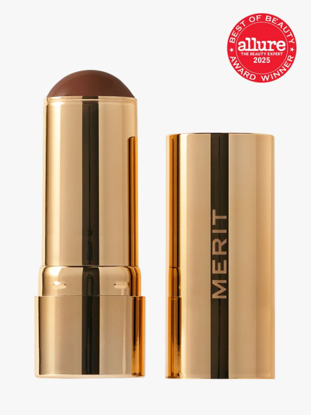 Merit Bronze Balm in branded gold twist up applicator on light gray background with red Allure Best of Beauty seal in the top right corner